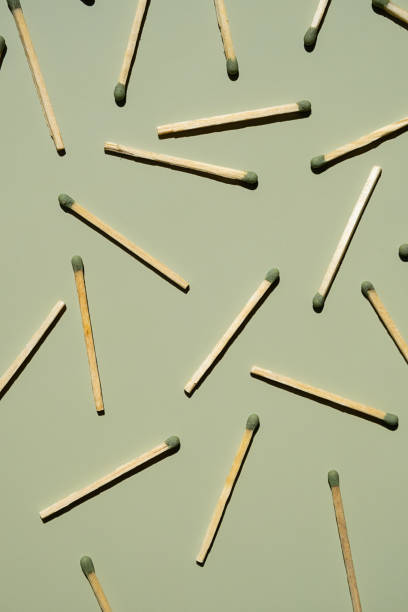 istock Wooden matchsticks scattered on a green background. 2163759799