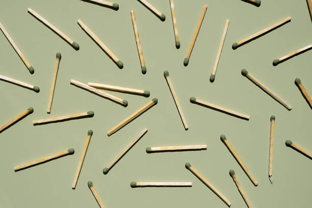 istock Wooden matchsticks scattered on a green background. 2163759801
