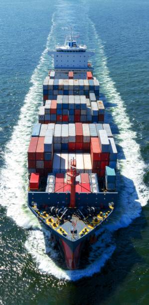 istock front view Cargo Container ship with contrail in the ocean ship carrying container and running for import export concept technology freight shipping by ship. 2163762188