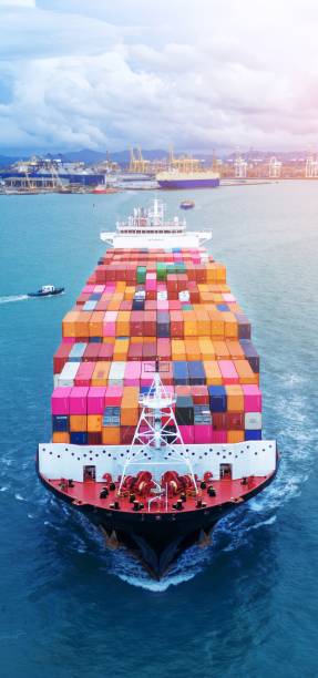istock Front view of  Cargo container ship carrying container and running out international container port customs shipyard sea port concept smart logistic service. 2163762264