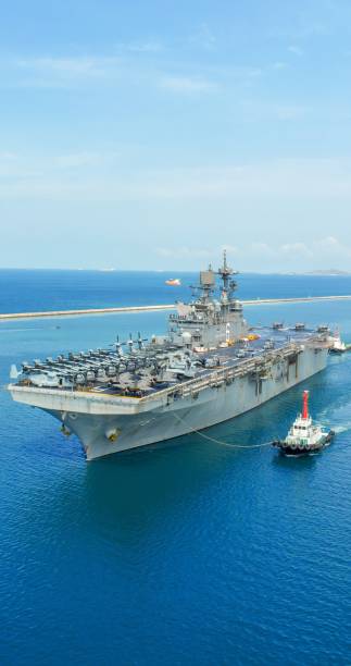 istock Portrait war ship Nuclear Navy ship at sunrise, Military navy carrier full loading fighter jet aircraft for prepare troops. nuclear carrier running in the ocean 2163762652