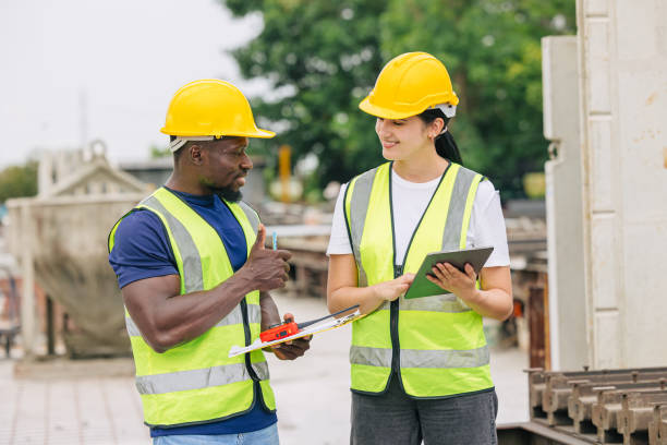 istock Engineer smart women working contact with African black worker in Precast concrete casting manufacturing company site inspector 2163762773