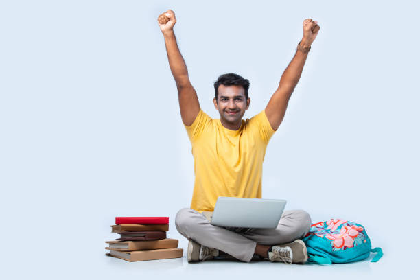 istock Asian Indian young college or university student studying while sitting on floor 2163764542