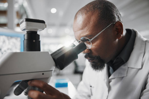 istock Black man, medical science and microscope in laboratory for analysis, innovation and results or research. Development, glasses and professional scientist in hospital for wellness, cure or health care 2163767401