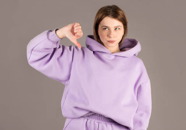 istock Woman showing thumbs down isolated on gray background 2163773205