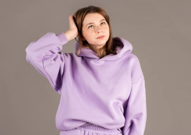 Young woman wearing purple sweater doubt expression, confuse and wonder concept, uncertain future isolated on gray background