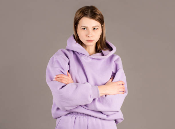 istock Indoor shot of angry grumpy young female dressed casually keeping arms folded, looking at camera with strict and skeptical expression, doesn't believe excuses of her unfaithful boyfriend 2163773271