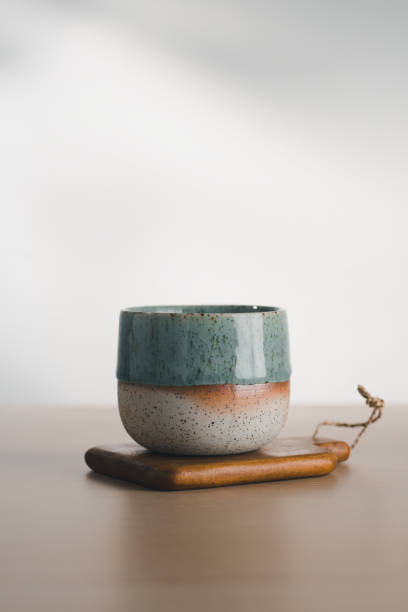 istock A dual-glazed ceramic cup rests on wood. 2163777478