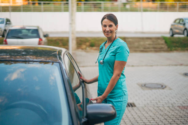 istock mature female nurse get in car after work 2163778151