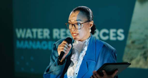 istock Conference, woman and workshop on stage for speech, talk or discussion for seminar host. Panel, mic and expert at speaker event for presentation on water management, sustainability or renewable forum 2163778213