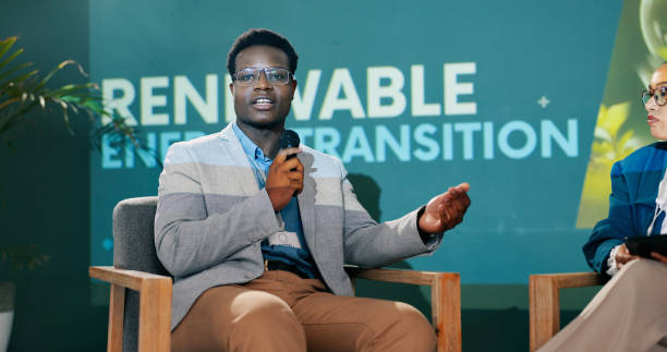 istock Man, woman and stage with conversation at conference for renewable energy, solution and global policy. People, questions and talk in public debate for sustainability, future and action for planet 2163778259
