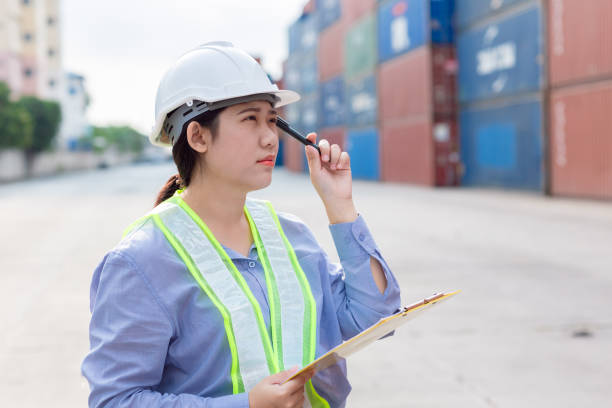 istock Asian Customs worker Thinking gesture work in logistic industry. Port officer working in shipping container yard. 2163784275