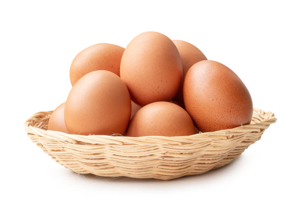 istock Front view of brown chicken eggs in stack in wicker basket isolated on white background with clipping path 2163785872