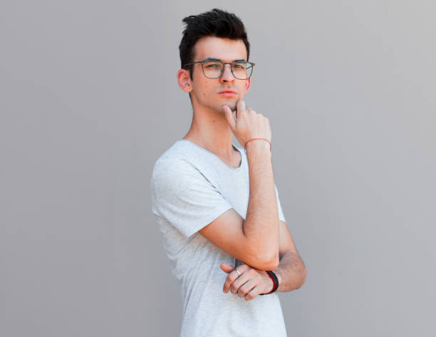 istock Young man with white shirt having doubts and with confuse face expression while scratching head on isolated grey background 2163789410