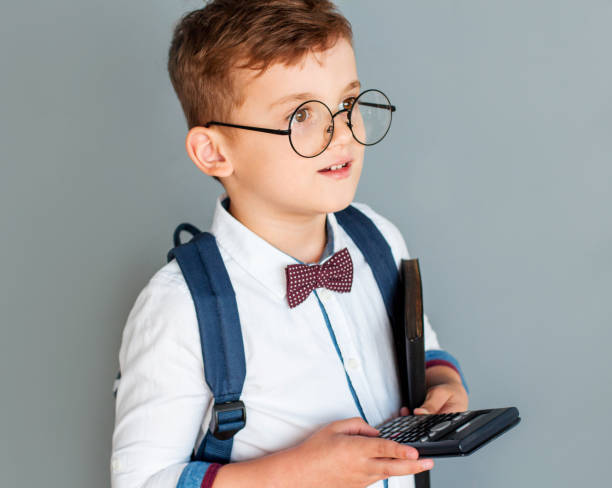 istock The five-year boy presses the button calculator isolated on grey 2163790569