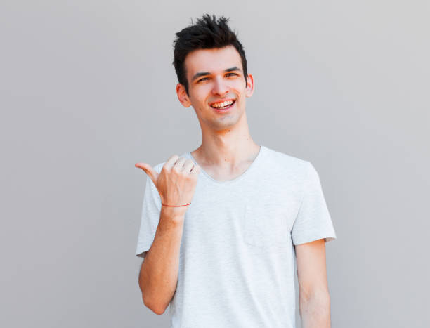 istock Cheerful toothy stylish man pointing with finger. 2163791258