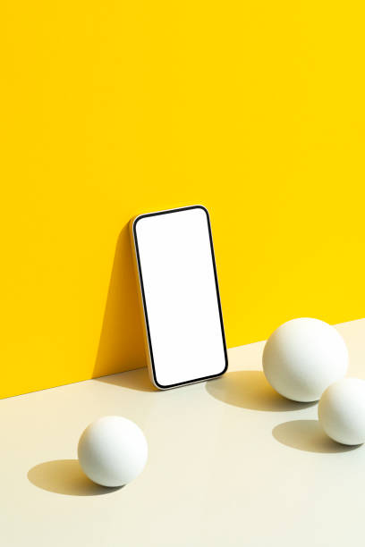 istock Blank screen smartphone mockup on yellow background with white spheres 2163795215