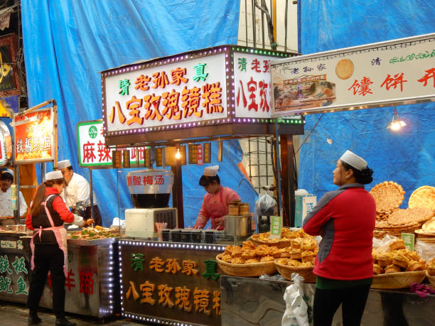 Xi'an, Shaanxi Province, China - November 15, 2017: A stall sells Chinese street food to tourists in the Xian Muslim Quarter.