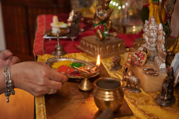 istock Indian Woman Lightning Candle At Altar 2163798886