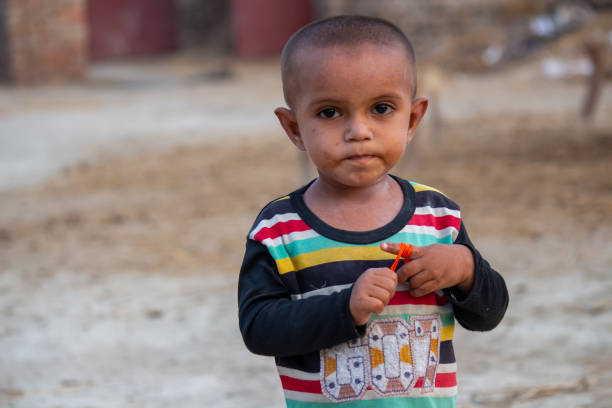 istock abandoned child boy stands outdoors in a rural village. 2163799632