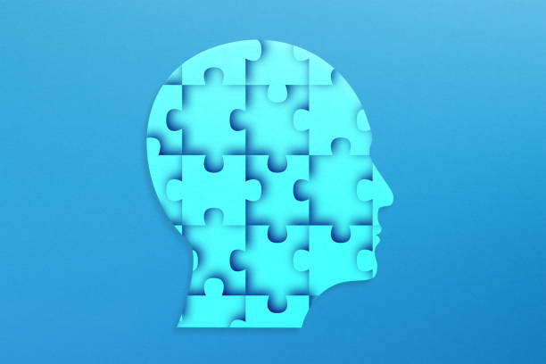 istock Human head made of jigsaw puzzle on blue background 2163800153