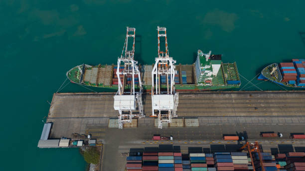 istock Container ship in export and import business and logistics. Shipping cargo to harbor by crane. Water transport International. Aerial view and top view. 2163801267