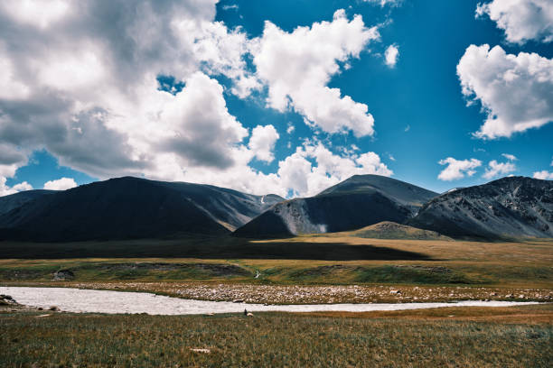 istock Mountain peaks above river flowing along remote alpine valley 2163803342