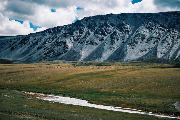 istock Ridge over mountain stream flowing along remote alpine valley 2163803383