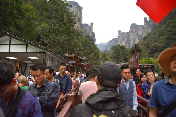 Woman hiking in epic  awe-inspiring Zhangjiajie Forest Park during trip experiential trip to China in winter