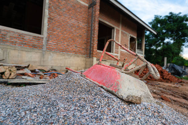 Bulk of crushed rock or pebble rock, material for house building, that placed on the construction work site. Close-up and selective focus.