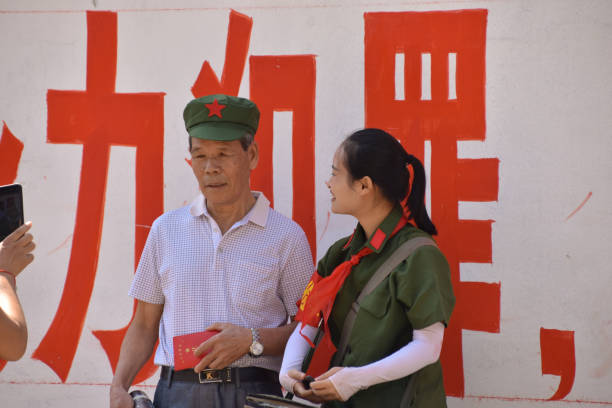 Yangshuo, Guangxi Province, China - October 3, 2018: A man and woman pose in Chinese communist uniform at Yangshuo.