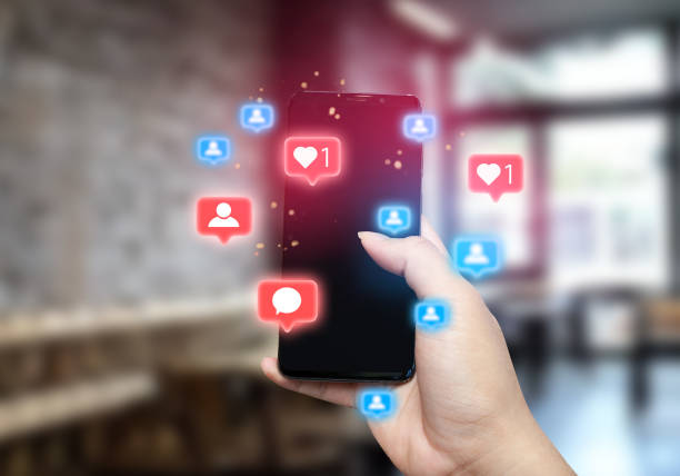 istock man using smartphone with social media icons pop up, blurred bright office background, social media, social network concept 2163805948