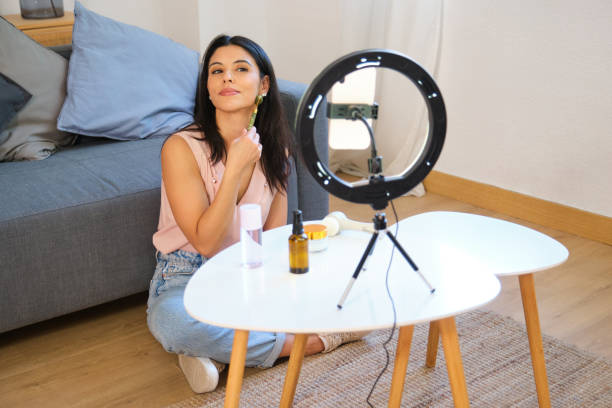 istock Beauty influencer applying gua sha stone on face during livestreaming 2163806037