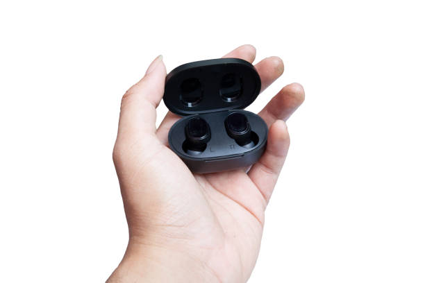 istock hand holding black wireless earphone 2163806097