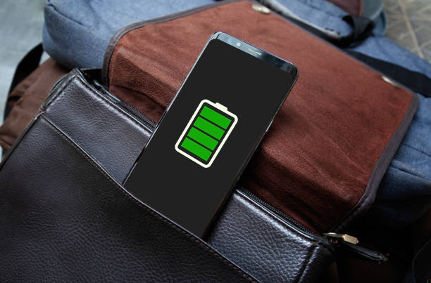 Full battery green icon in a smartphone screen. on a brown bag