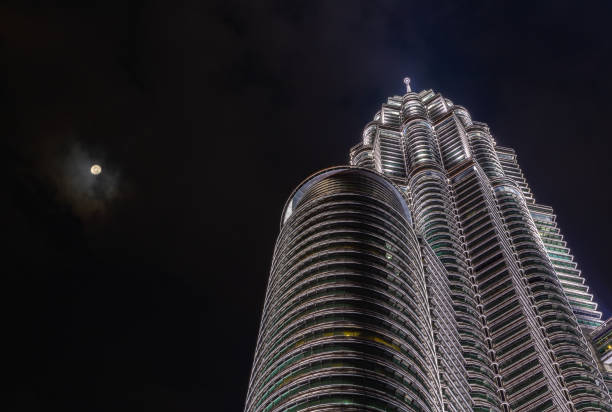 A picture of the Petronas Twin Towers as seen from below at night.