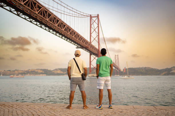 istock Men looking at the 25th of April Bridge 2163807916