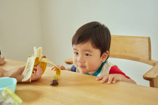 A boy eating a banana