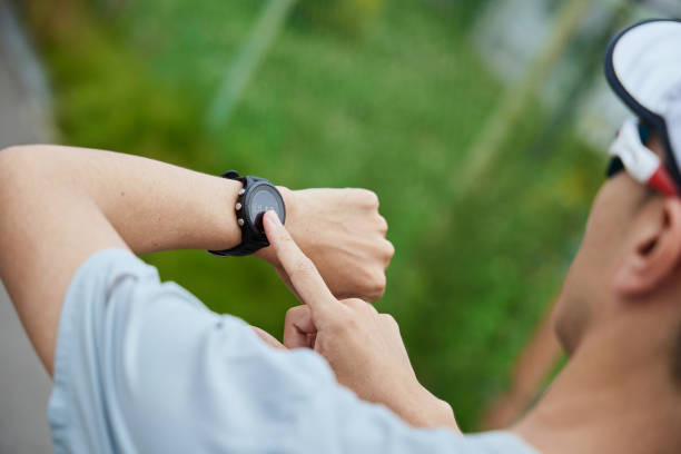 istock Man running in the park wearing a smartwatch 2163812195