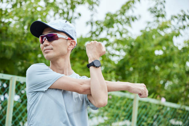 istock Man running in the park wearing a smartwatch 2163812200