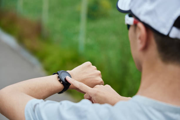 istock Man running in the park wearing a smartwatch 2163812202