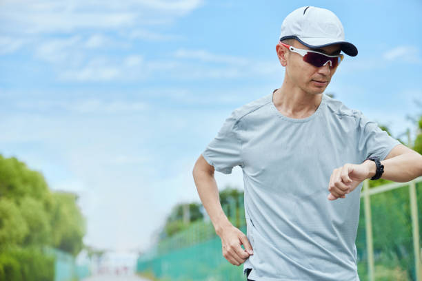 istock Man running in the park wearing a smartwatch 2163812204