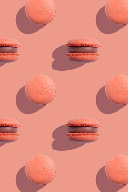 istock Coral color macaroons cookies on a coral background 2163814140