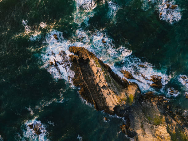 Aerial view of sunset over rocky coastline, Odeceixe