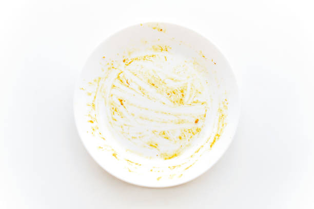 istock Dirty plate with curry sauce stains food leftover on the table. 2163824049