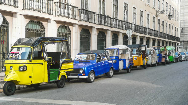 Tourist vehicles with driver for guided tours of the city of Lisbon (Portugal). Copy space