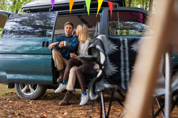 istock Young Couple Relaxing with Tea in Camp Setting 2163825216