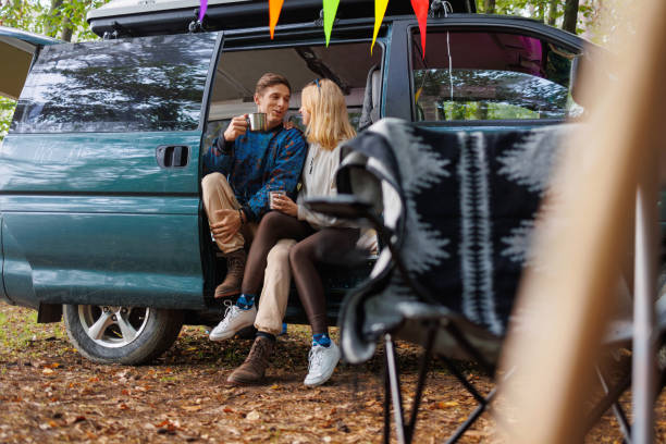 istock Restful Scene: Couple with Tea by the Camper 2163825242