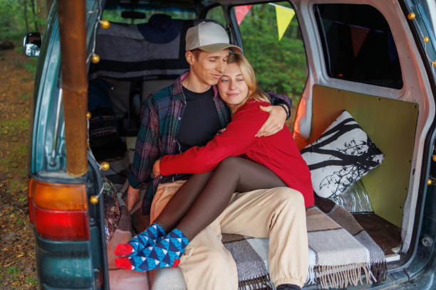 istock Intimate Forest Escape: Young Couple Resting in Camper 2163825710