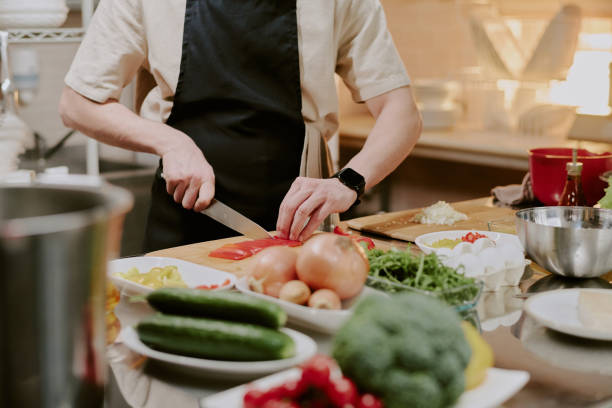 istock Male Cook Slicing Bell Pepper 2163829023